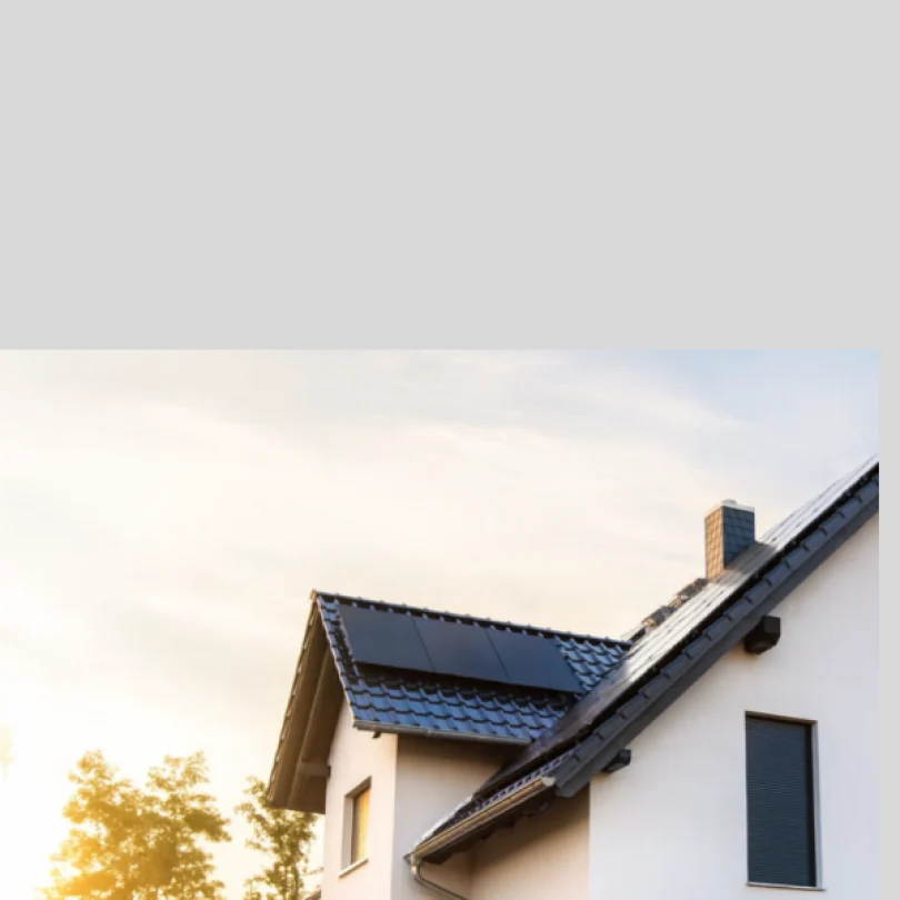 Modern house with solar panels at sunset